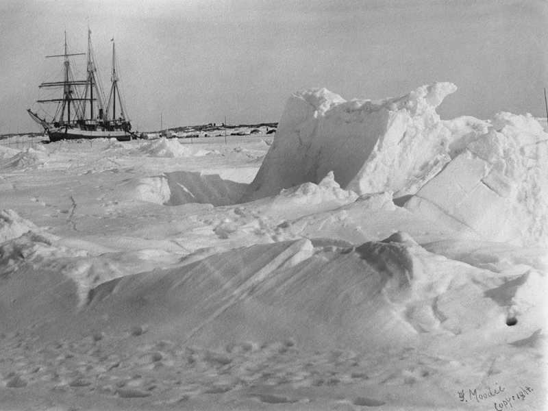 A very old photograph of a ship caught in arctic sea ice