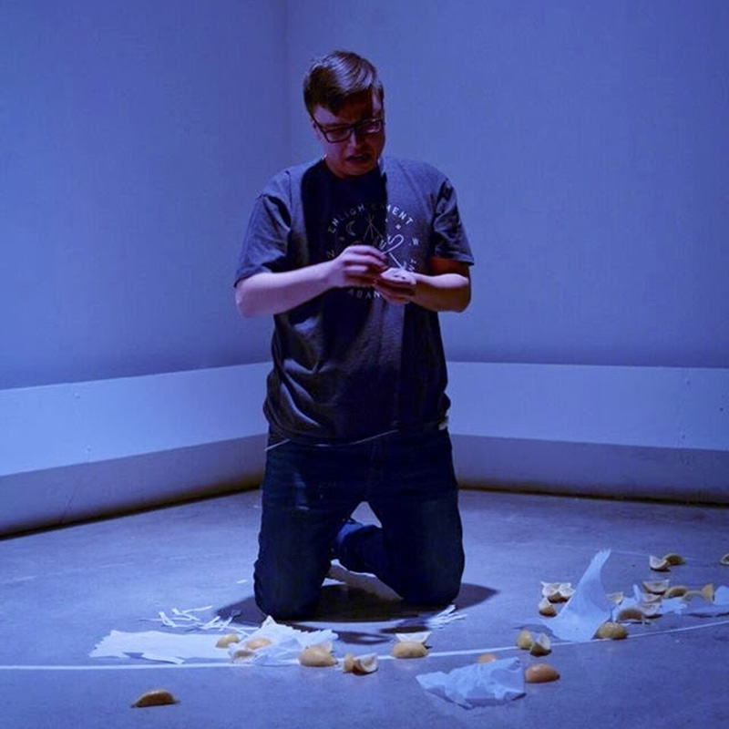 A blue room with Dan Cardinal McCartney surrounded by cut lemons