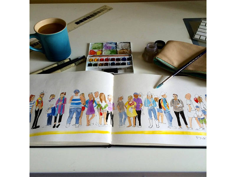 An open sketch book featuring people standing on a train platform with watercolours near by