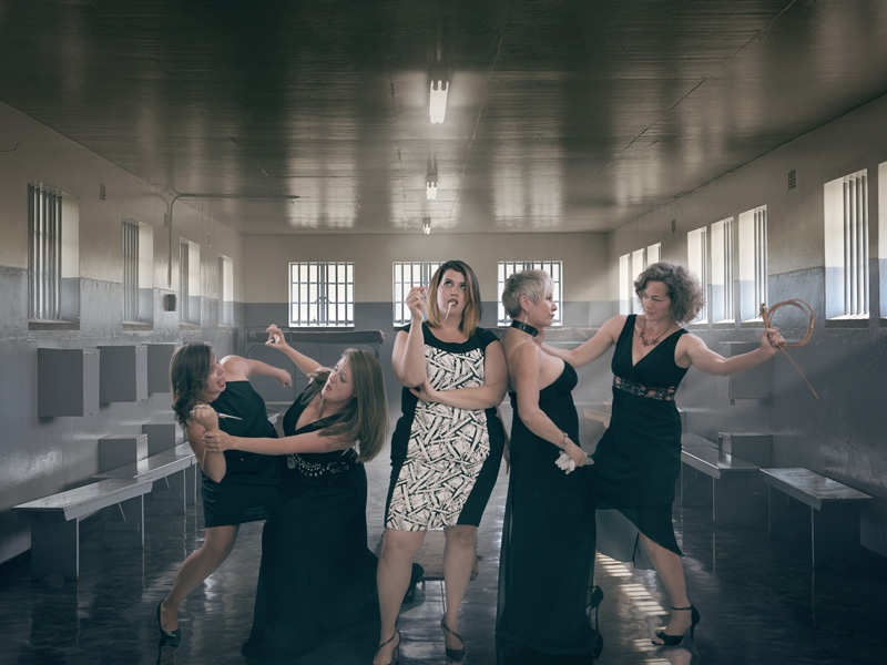 Five opera singers in a prison-like setting