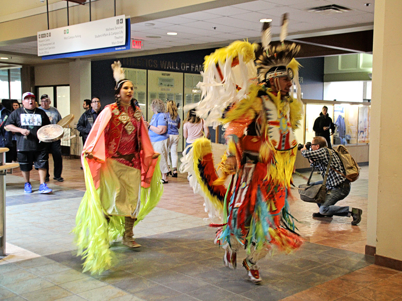 Indigenous performers make their way through the halls of Mount Royal University