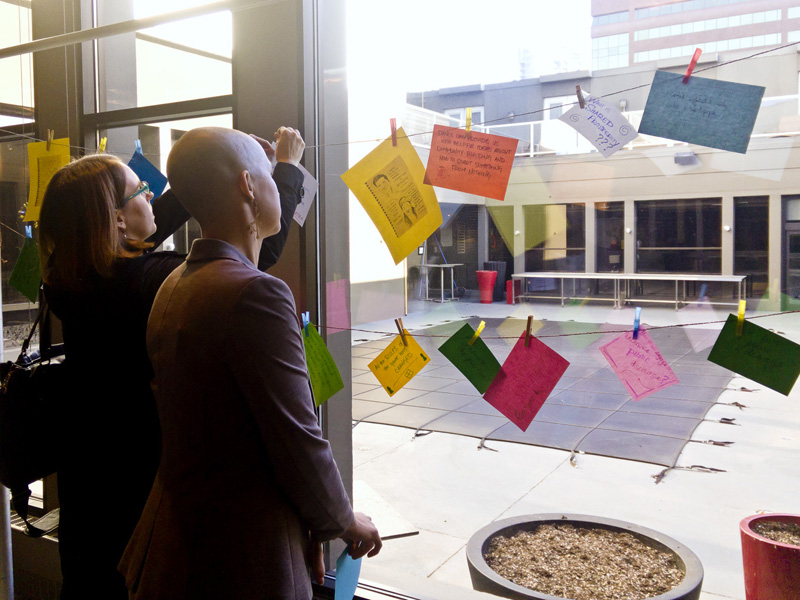 Participants at the Creative Calgary Congress add their messages to the clothesline