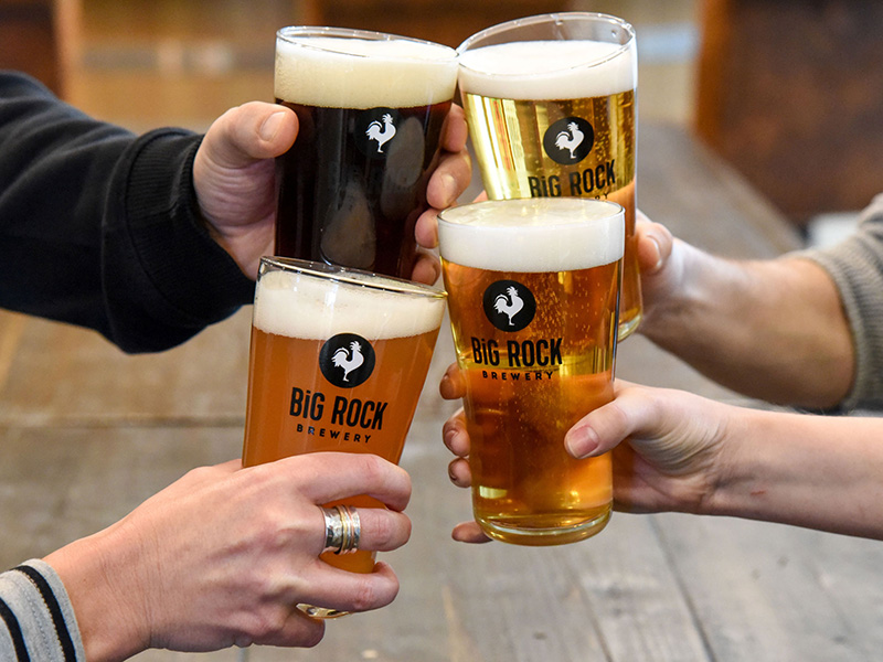 Four pints of Big Rock Beer being toasted