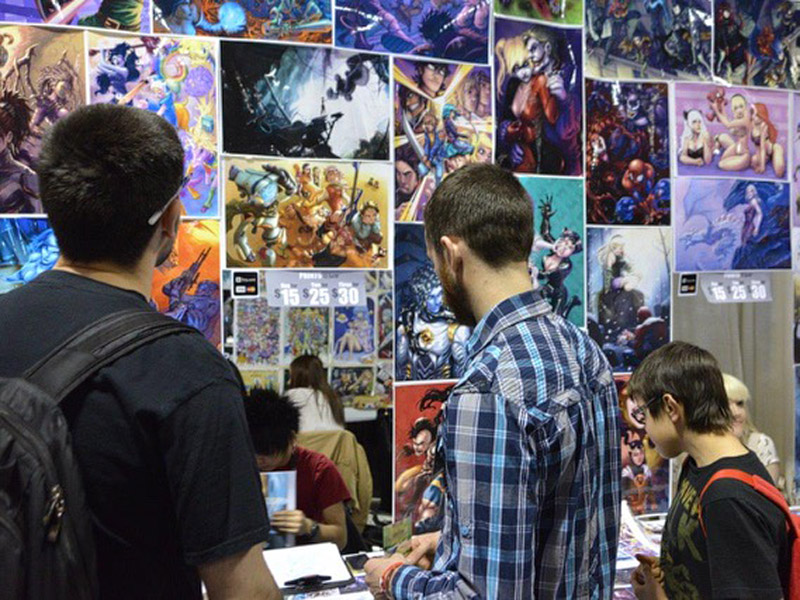 Expo goers explore the booth of an artist at the Calgary Comic & Entertainment Expo