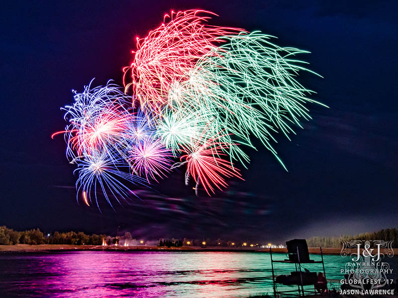 Fireworks reflect over water