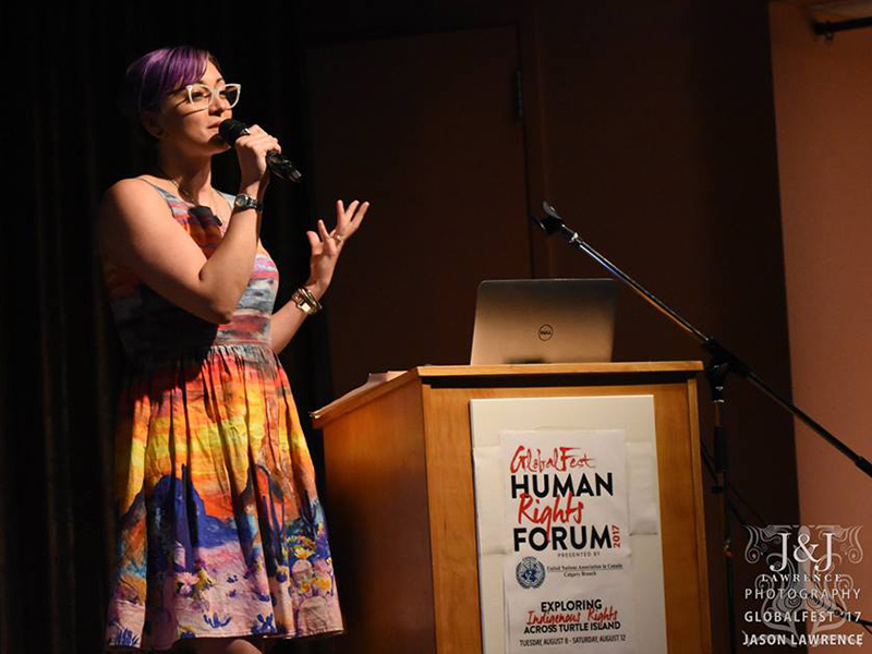 Rebecca Dawn presents on stage at the GlobalFest Human Rights Forum in 2017