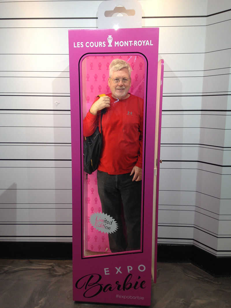 A photo of Richard White standing in a full sized Barbie box