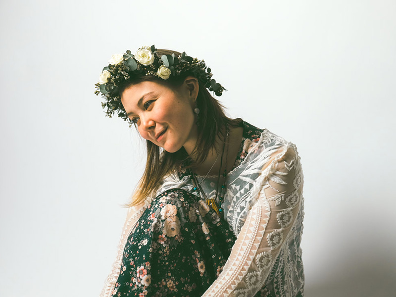 A promotional photo of musician Annie Sumi wearing a flower crown