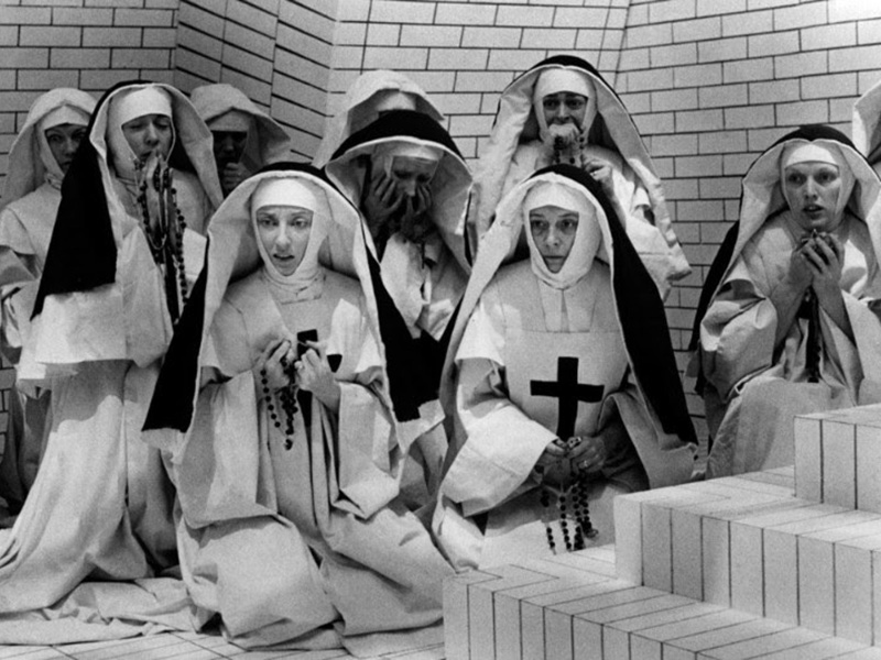 A black and white still of a group of nuns