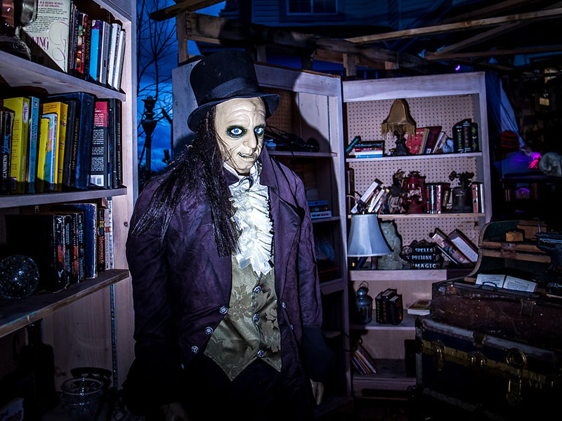 A ghoul stands amongst a scene of househould clutter