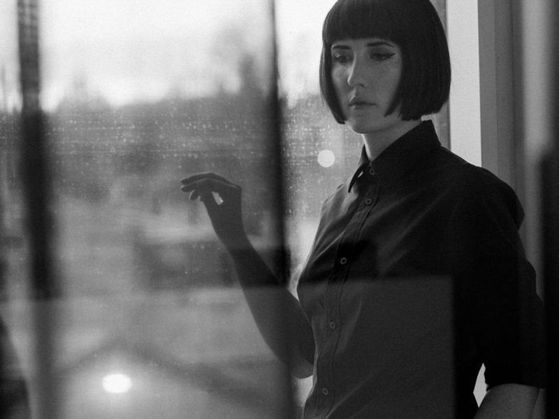 A photo of Ellen Doty through a relective window