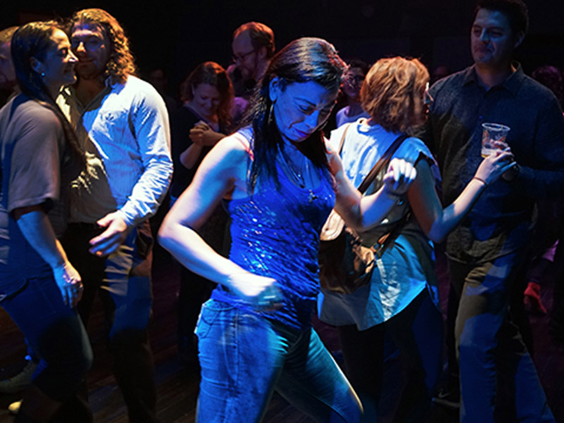 Writer, performer, and activist Carmen Aguirre dances in a crowd