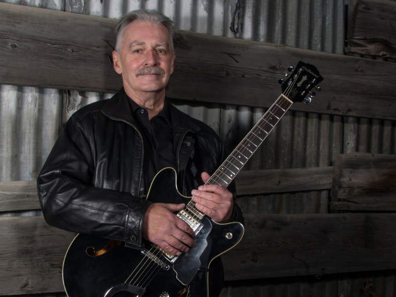 A photo of Thomas T Blues holding a guitar