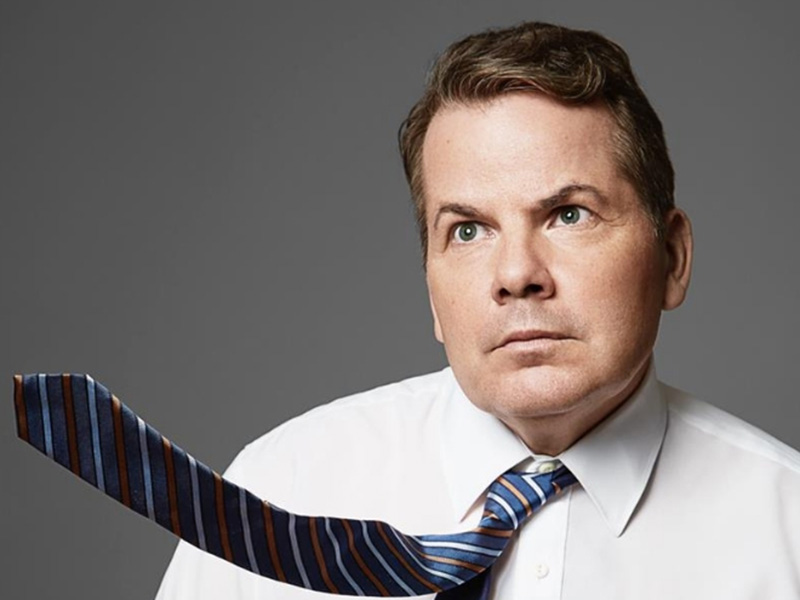 A photo of Bruce McCulloch with his tie blowing in the breeze