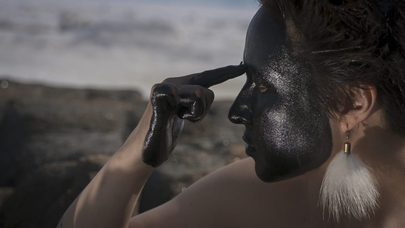 Laakkuluk Williamson-Bathory paints their face black 
