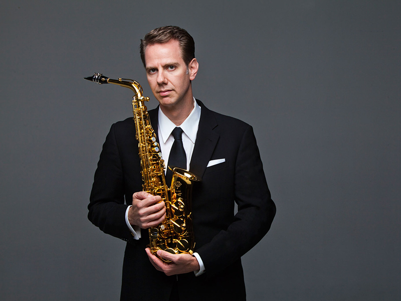 Timothy McAllister holds his saxophone