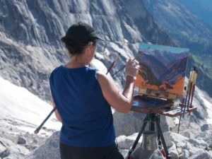 picture Janet B. Armstrong painting on a mountain