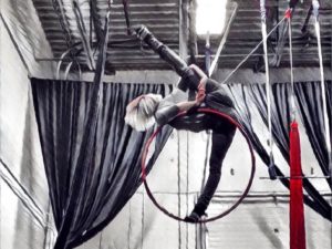 A photo of Sarah Curts performing aerial arts with hoop
