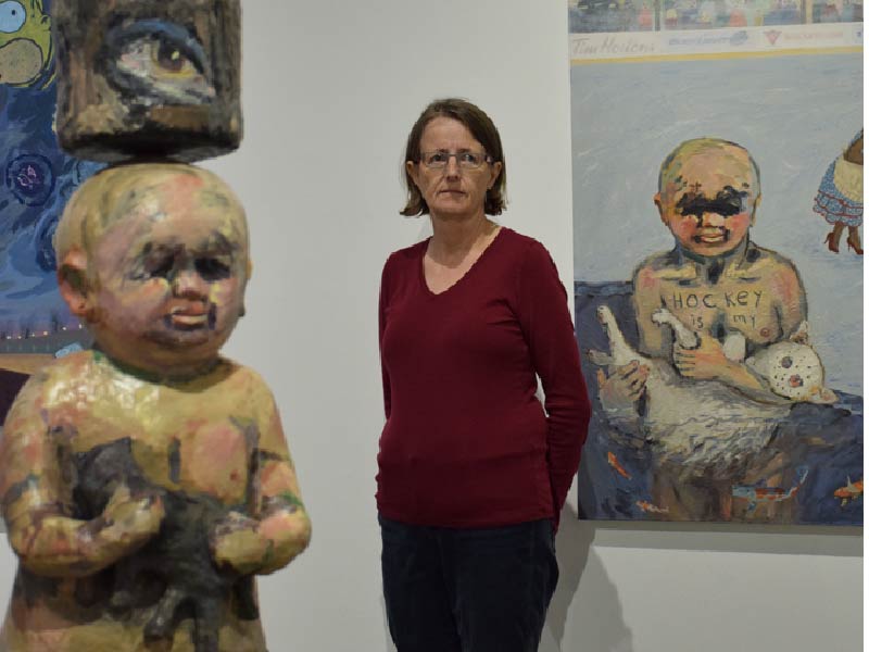 A photo of Violet Costello with artwork
