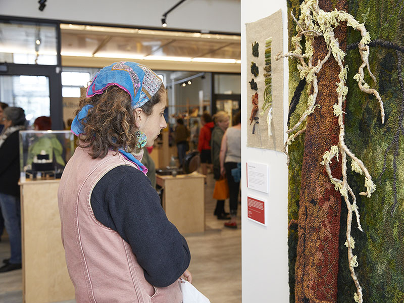A person looks at a display at the Alberta Craft Gallery