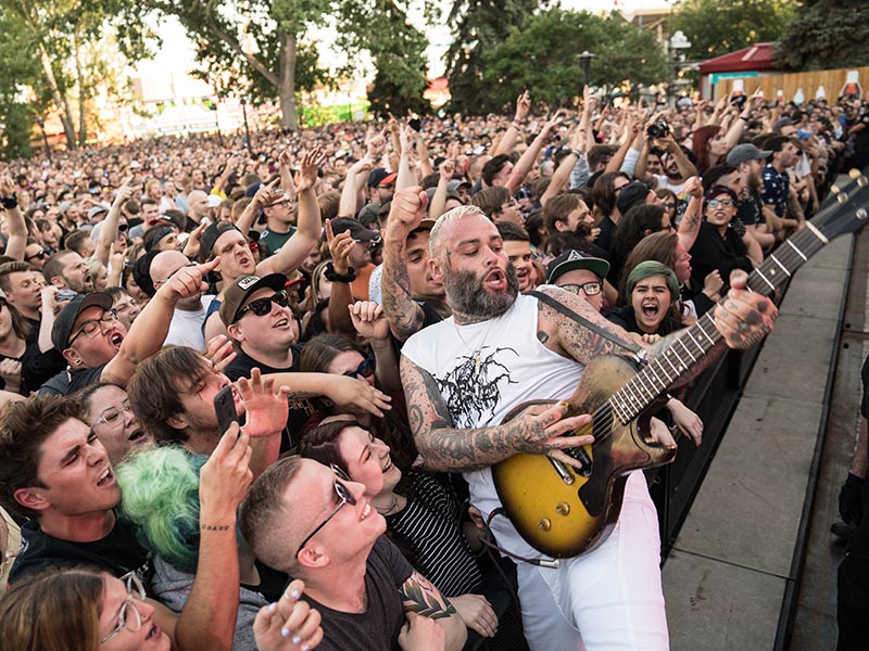Fans support a guitarist at the Coca-Cola Stage