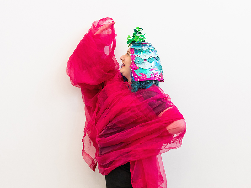 Performer Alicia Morrison draped in a colourful costume