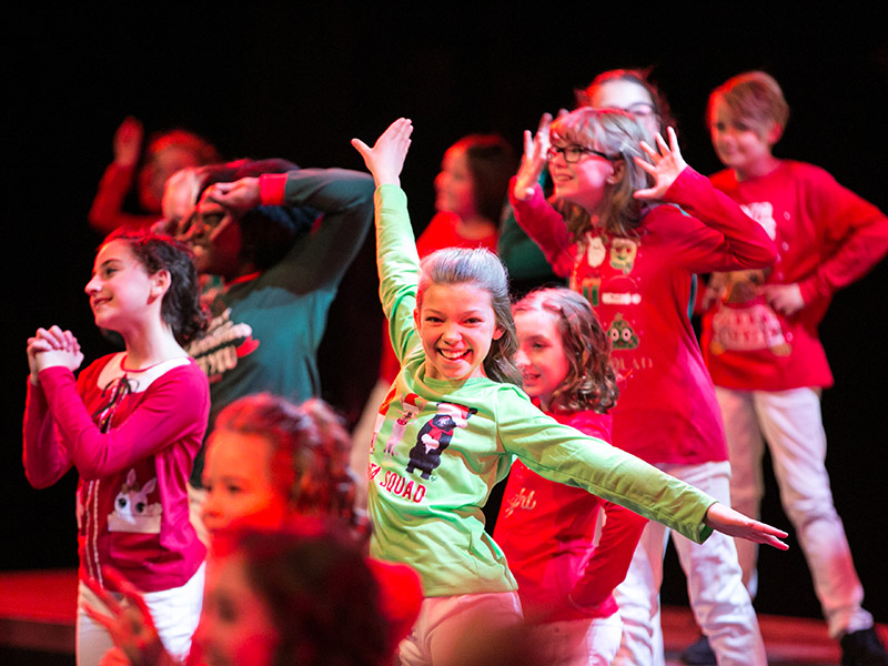 Youth Singers of Calgary members on stage in Christmas pajamas
