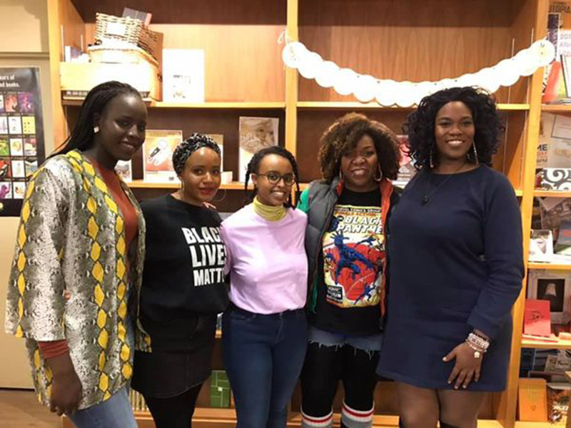 A photo of five Black poets and perfomers at Shelf Life Books