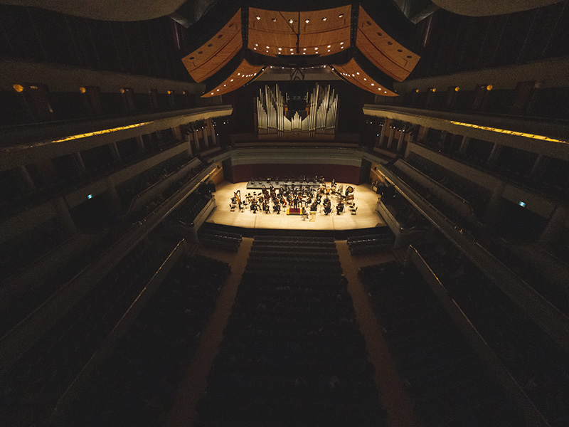 A photo from the upper balcony of the Jack Singer Concert Hall with the Calgary Philharmonic Orchestra on stage