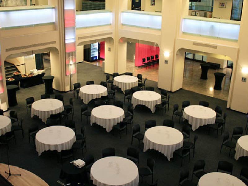 Image of tables set up in the Jack Singer Lobby at Arts Commons