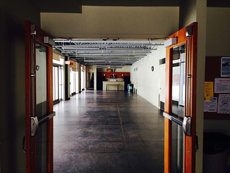 Image of an empty lower hall at the Bridgeland Riverside Community Association, captured from main entrance