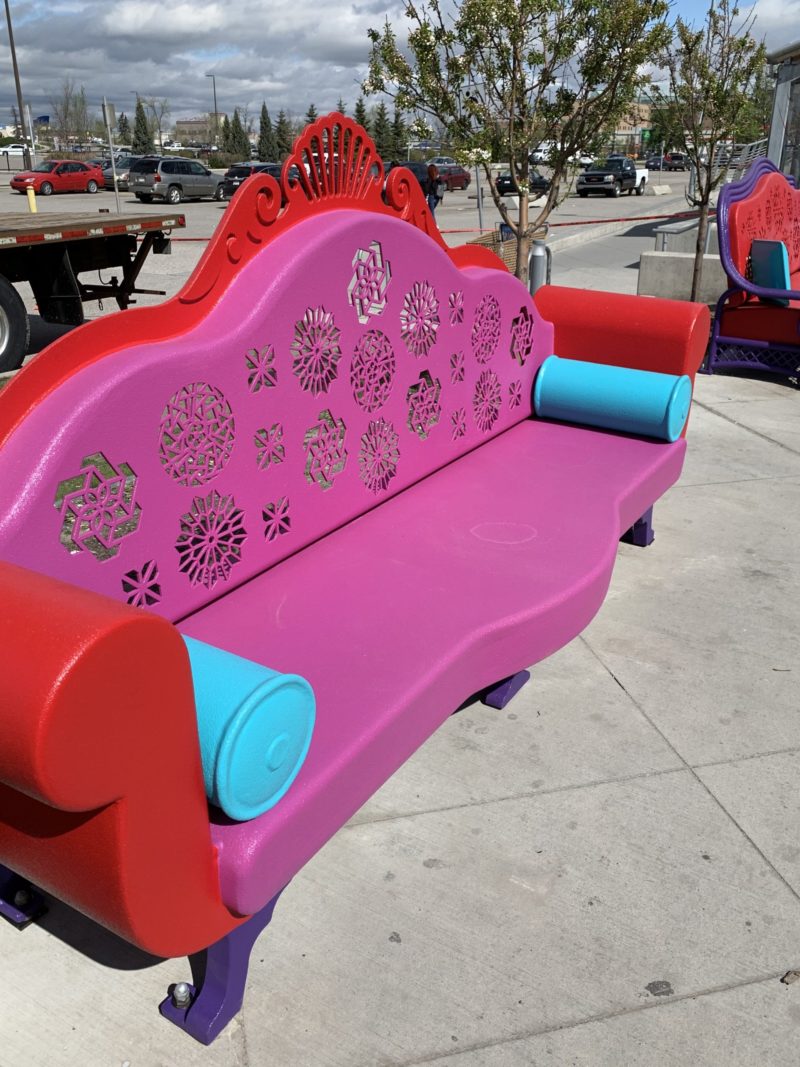 A metal bench shaped like a floral couch