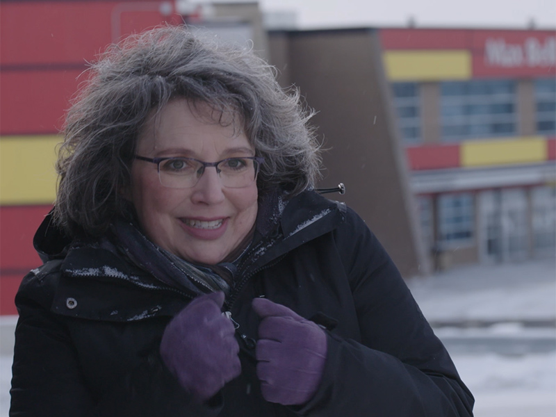 Julie Freedman Smith in front of a snowy Max Bell Arena