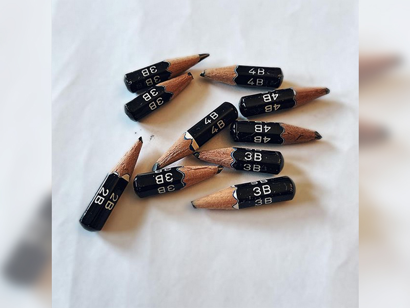 An image of 10 artist pencils sharpened to each nub