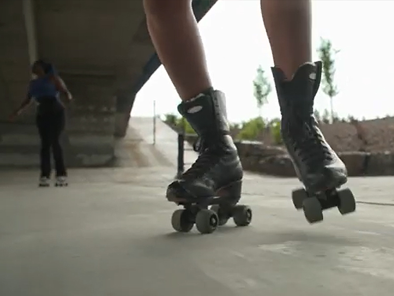 A still of Ador Nwofor and Livvy Skates rollerskating