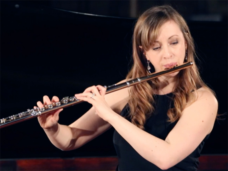 A photo of Sarah McDonald playing the flute