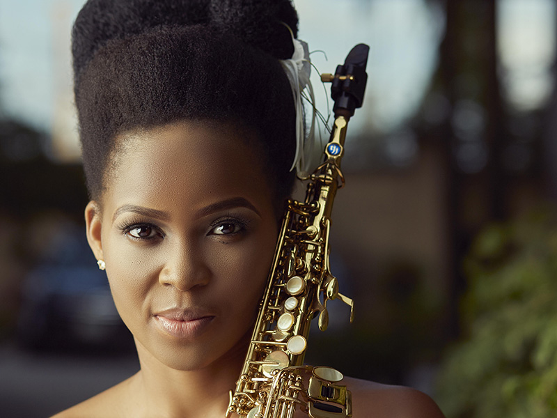 A promo photo of Perpetual Atife with her saxophone