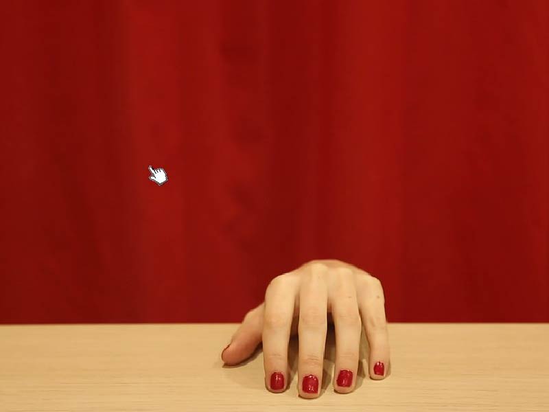 Image of hand resting on table with red background