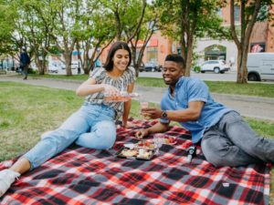 Image of two people enjoying a picnic at Tomkins Park