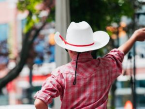Image of man with cowboy hat on from the back