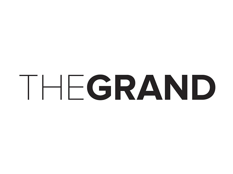 A logo for The GRAND on a white background