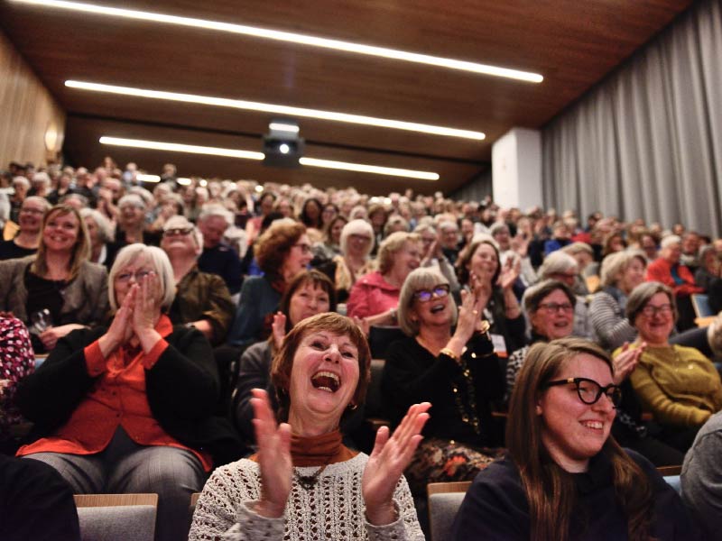 An image of a joyful, applauding audience
