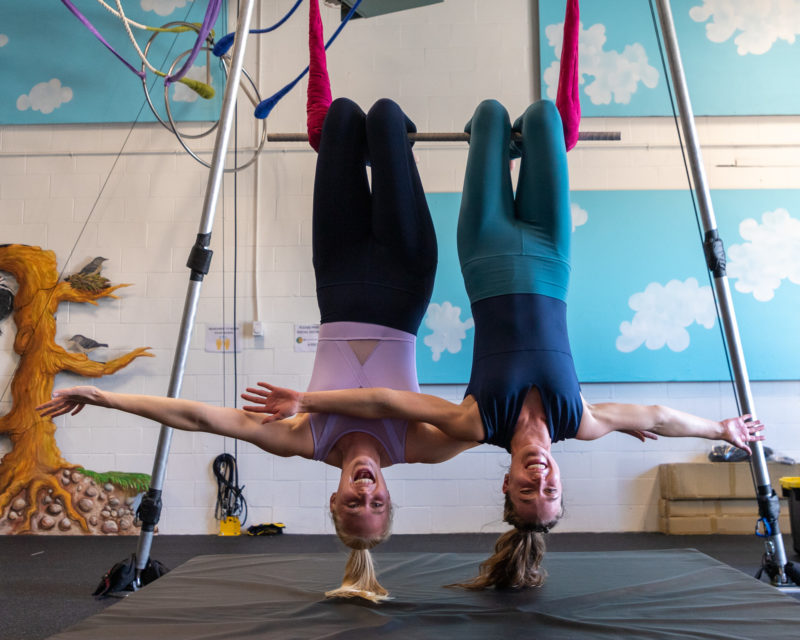 Photograph of women upside-down doing aerial moves | Fall Adult Circus and Aerial Classes