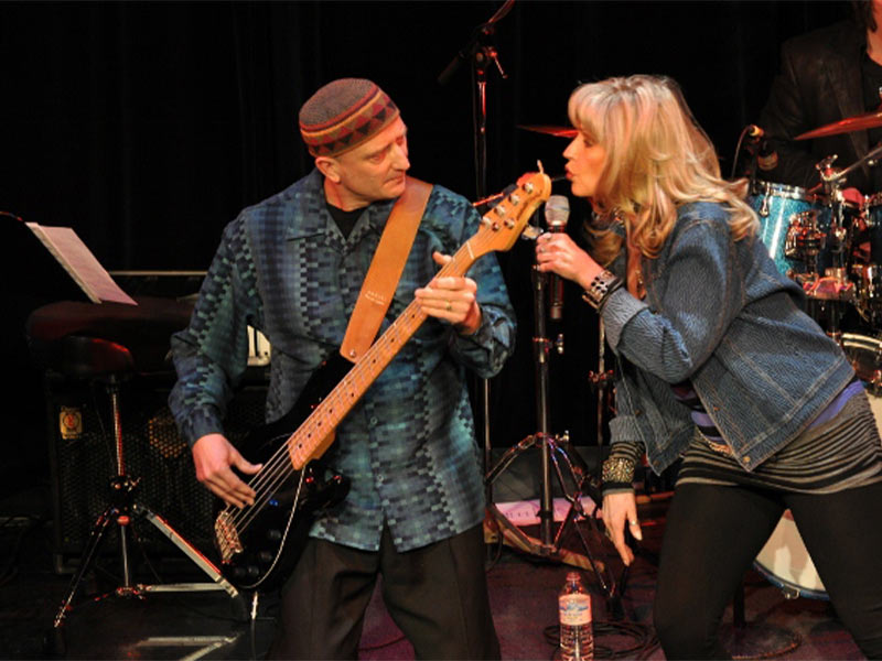 An image of Sherry Kennedy singing alongside a bass player