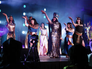 An image of the members of Calgary's Egyptian Folk Dance Academy performing on stage