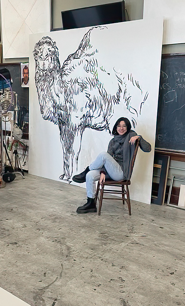 Image of artist in front of a work in progress 