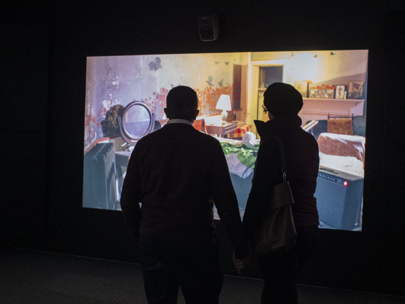 Image of two people viewing "The Visitors" exhibition by Ragnar Kjartansson