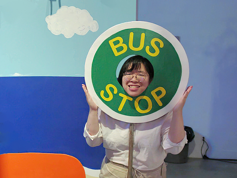 An image of Teresa Tam with a Bus Stop Sign