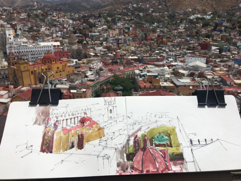 Photo of a water colour sketch book overlooking this Mexican city