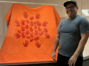Image of Dale Swampy with community star blanket